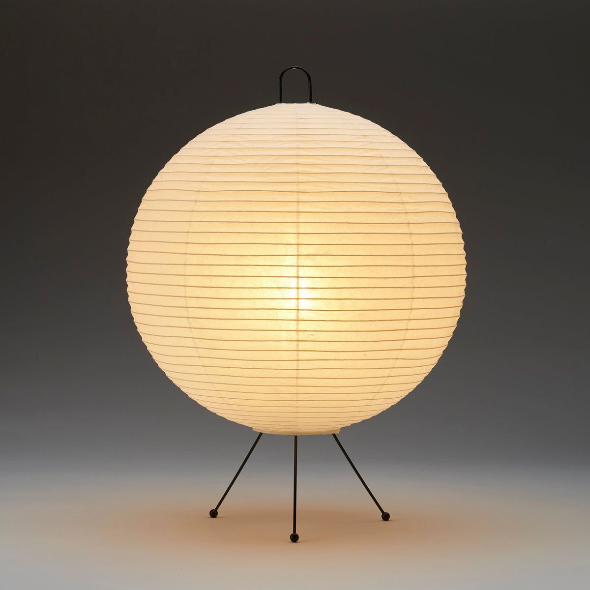Spherical lamp with a paper shade on a dark background