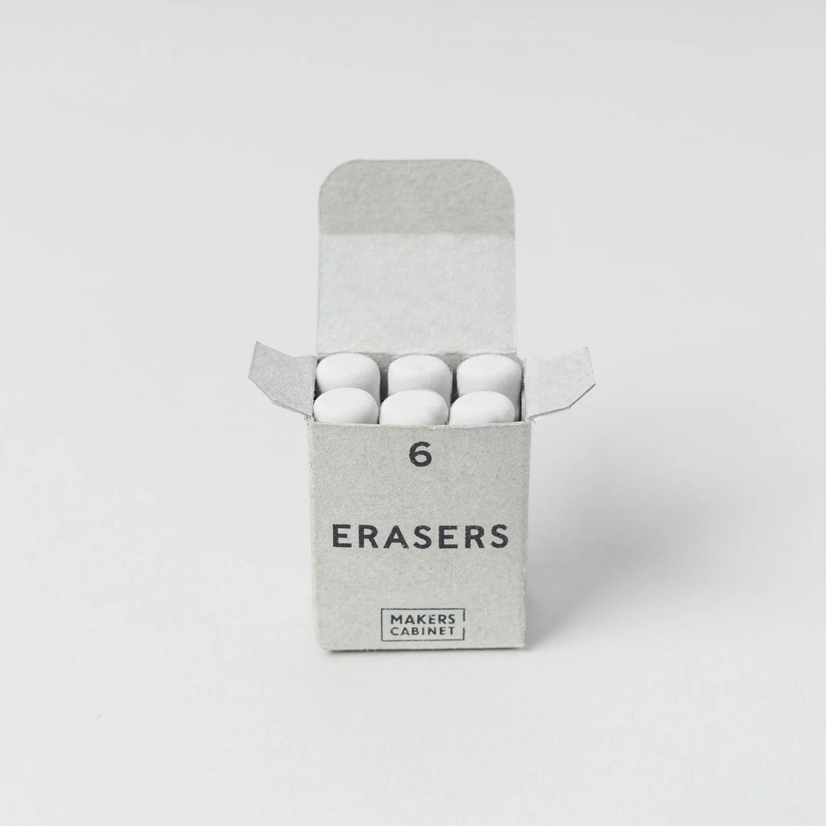 Box of erasers with 'Makers Cabinet' branding on a light gray background