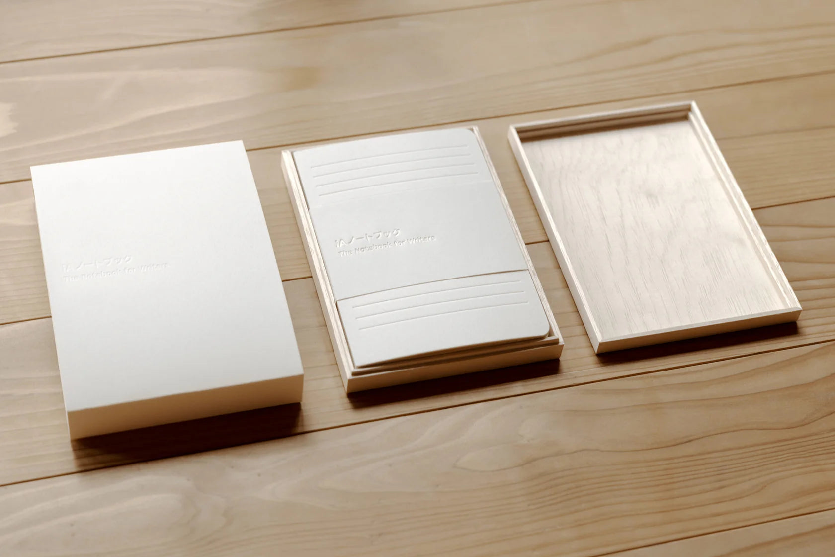 Three notebooks on a wooden surface