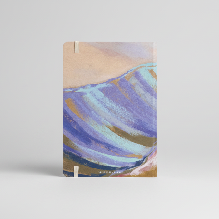 Notebook with abstract mountain design on a white background