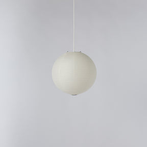 A spherical pendant light with a ribbed, pleated paper or fabric shade in an off-white color, suspended by a thin white cord against a plain light gray background.