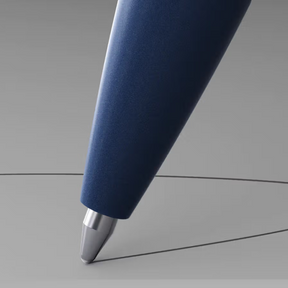 Blue pen writing on a gray surface