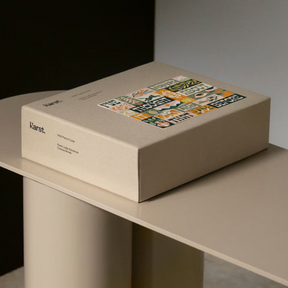 Beige box with colorful label on a light gray surface