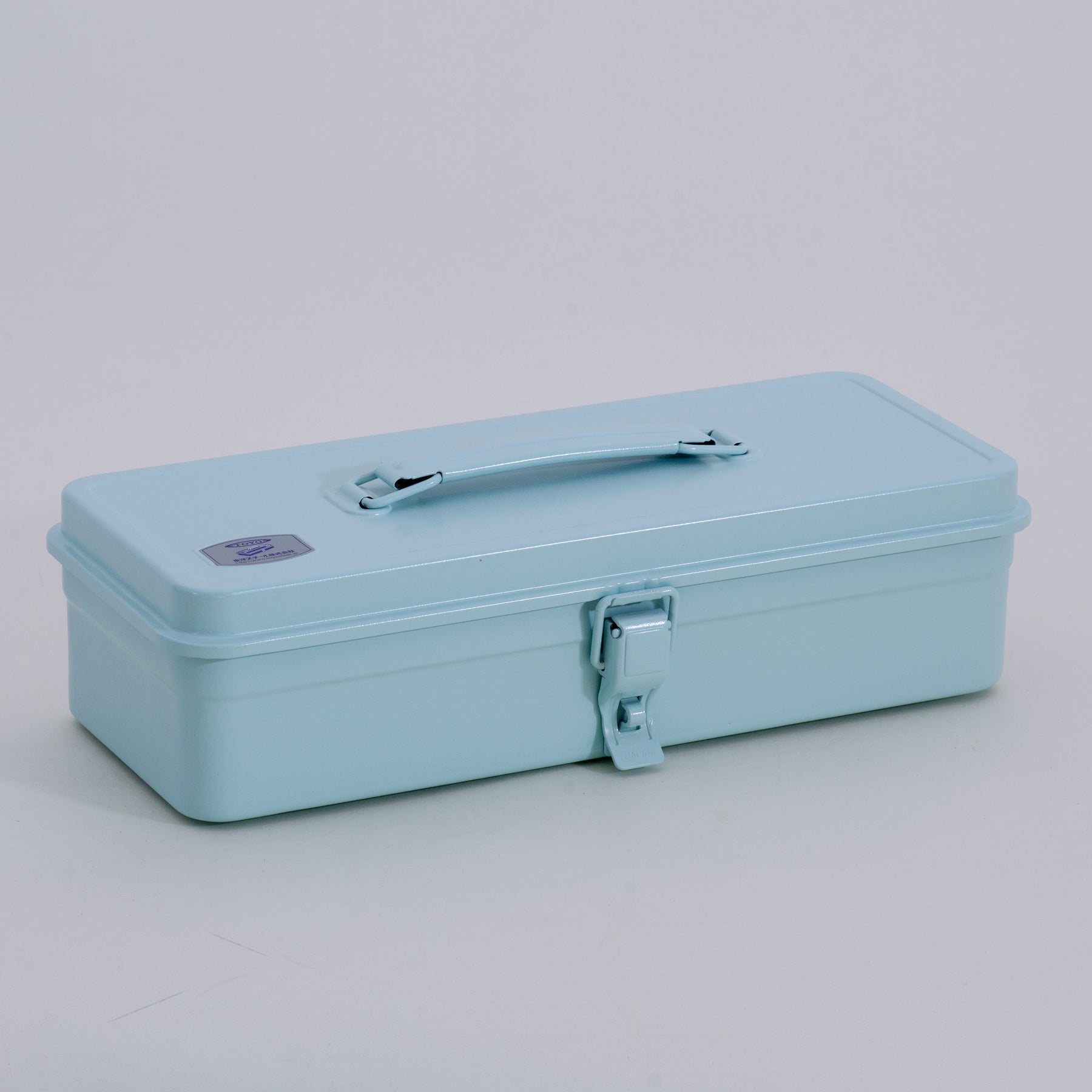 glacier Toyo Steel metal toolbox with a smooth enamel finish, long rectangular shape, top carry handle, and single front latch, shown closed on a neutral studio background.