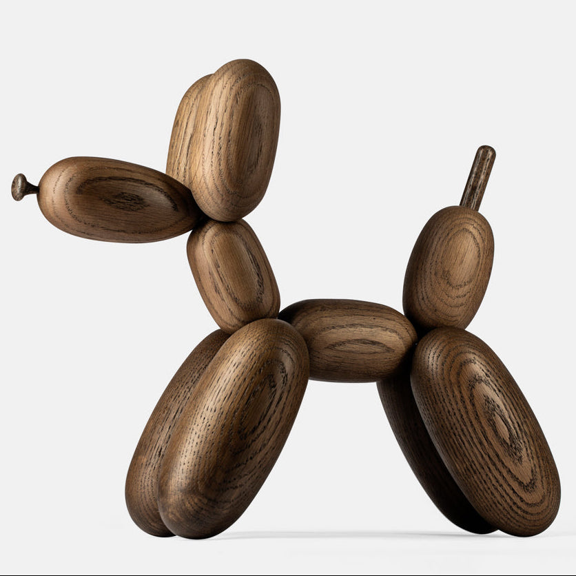 Wooden sculpture of a dog on a white background