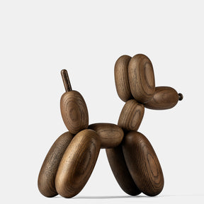 Wooden balloon dog sculpture on a white background