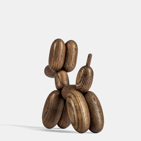 Wooden balloon dog sculpture on a white background