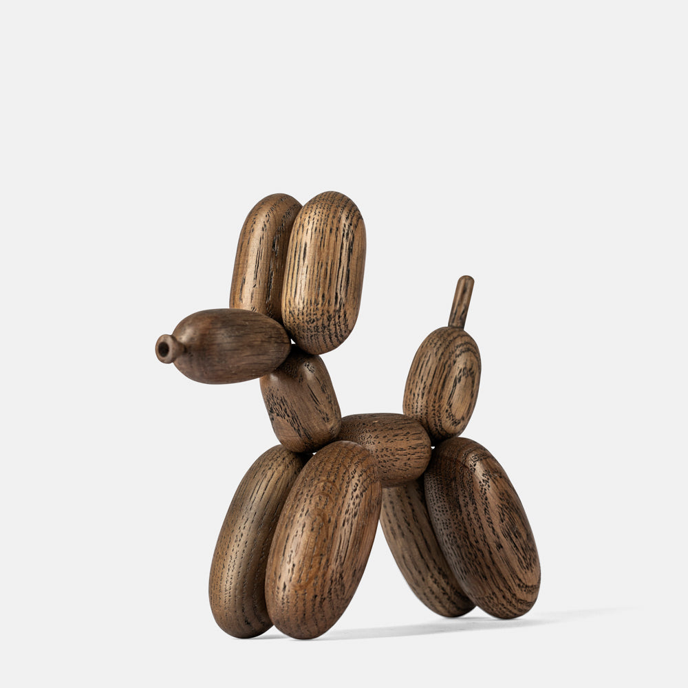 Wooden dog sculpture on a white background