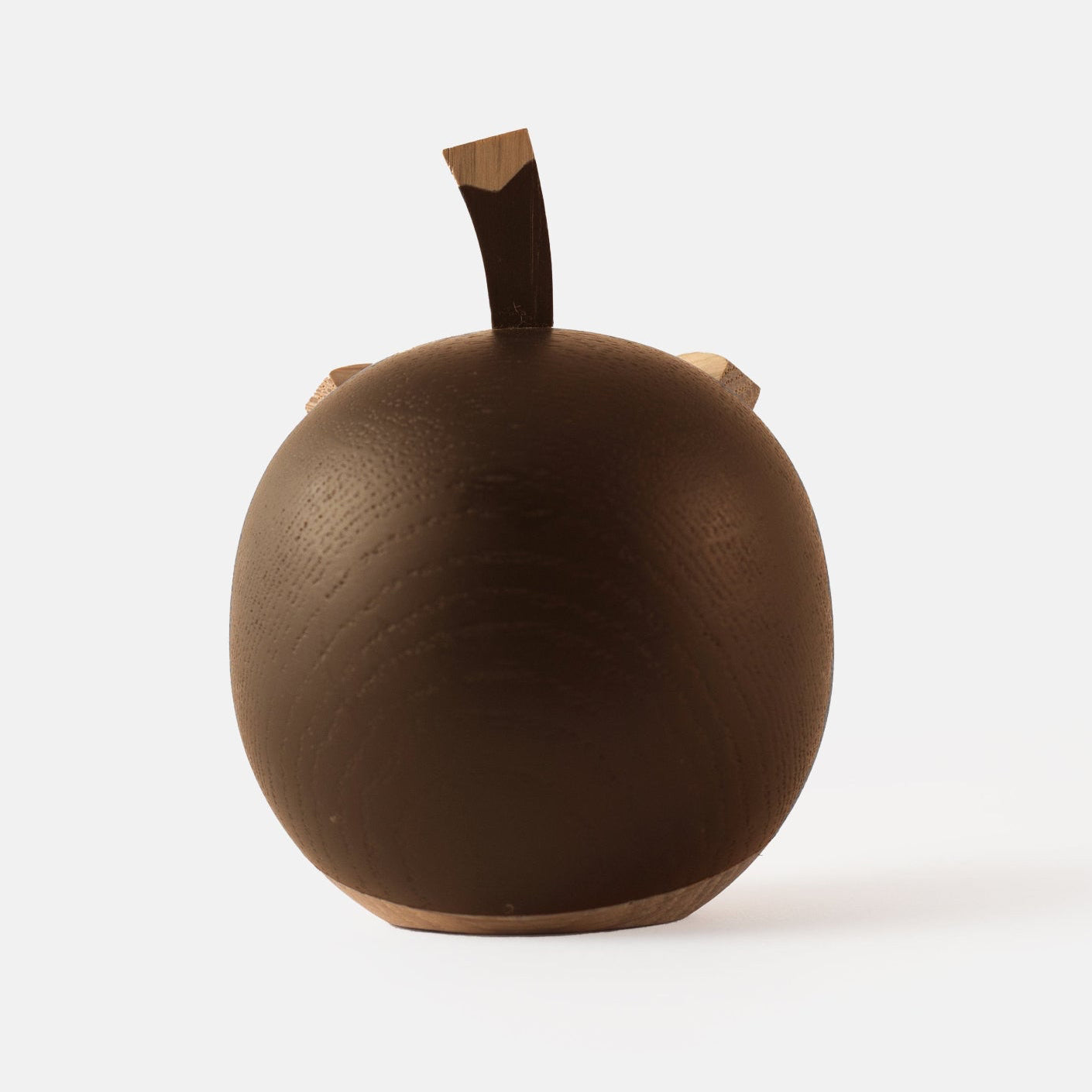 Back view of wooden figurine of an animated cartoon bird character carved from dark and light wood, featuring a round body, prominent beak, expressive eye details, a small top stem, visible natural wood grain, and a smooth matte surface on a plain white background.