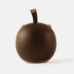 Back view of wooden figurine of an animated cartoon bird character carved from dark and light wood, featuring a round body, prominent beak, expressive eye details, a small top stem, visible natural wood grain, and a smooth matte surface on a plain white background.