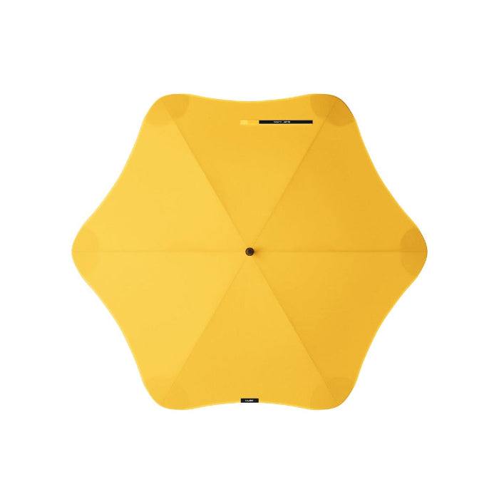 Yellow umbrella with a unique geometric design on a white background
