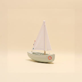Model sailboat on a beige background