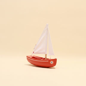 Model sailboat on a beige background