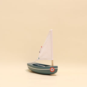 Model sailboat on a beige background