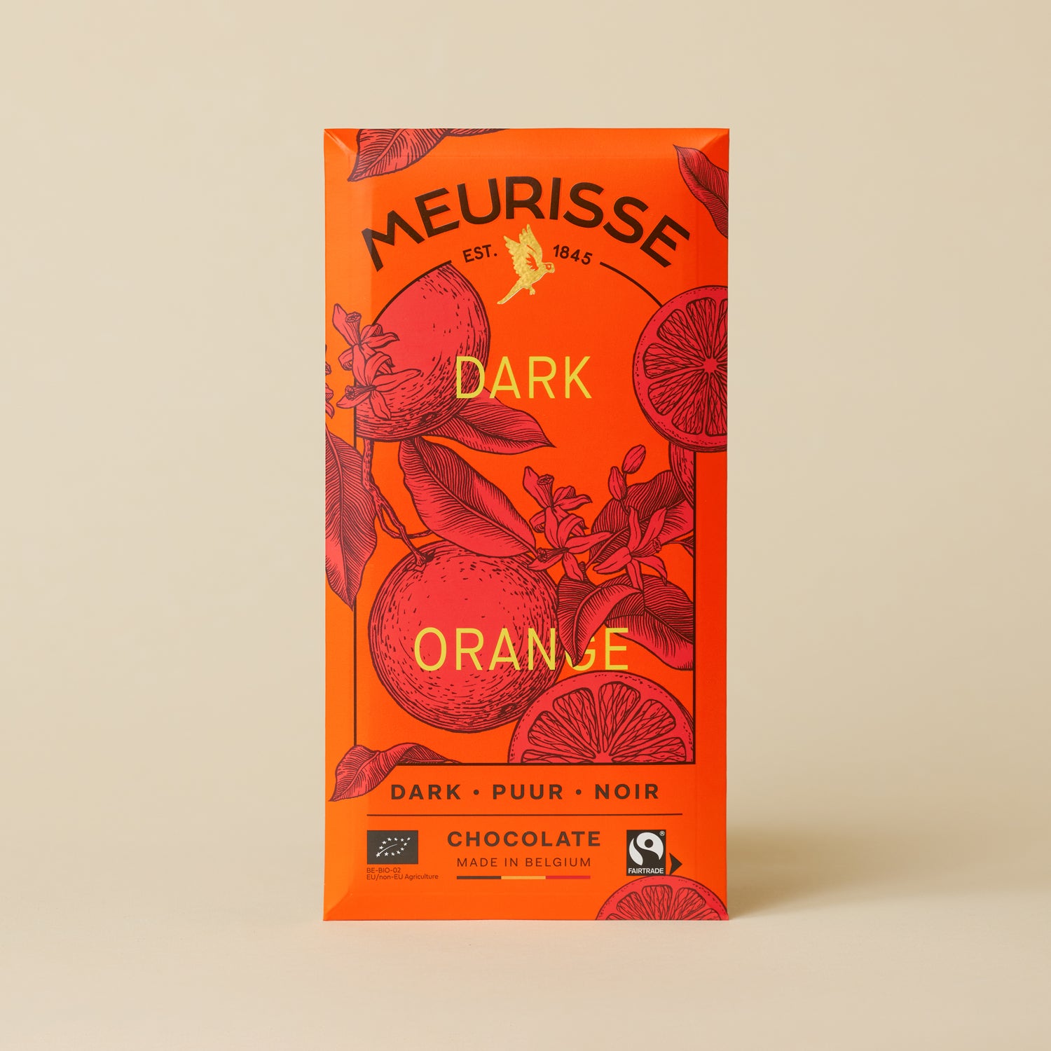 Meurisse Dark Orange chocolate bar in bright orange packaging with illustrated oranges and leaves, labeled ‘Dark Orange,’ standing upright against a soft beige background.