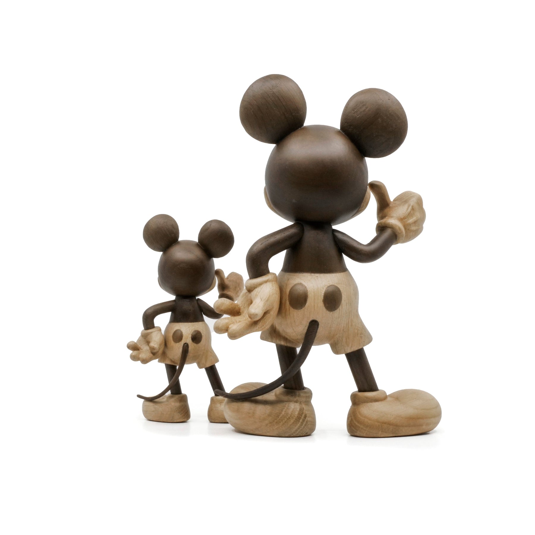 Wooden Mickey Mouse figurines on a white background