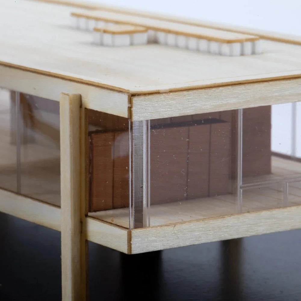 Model of a building with a clear base on a dark surface