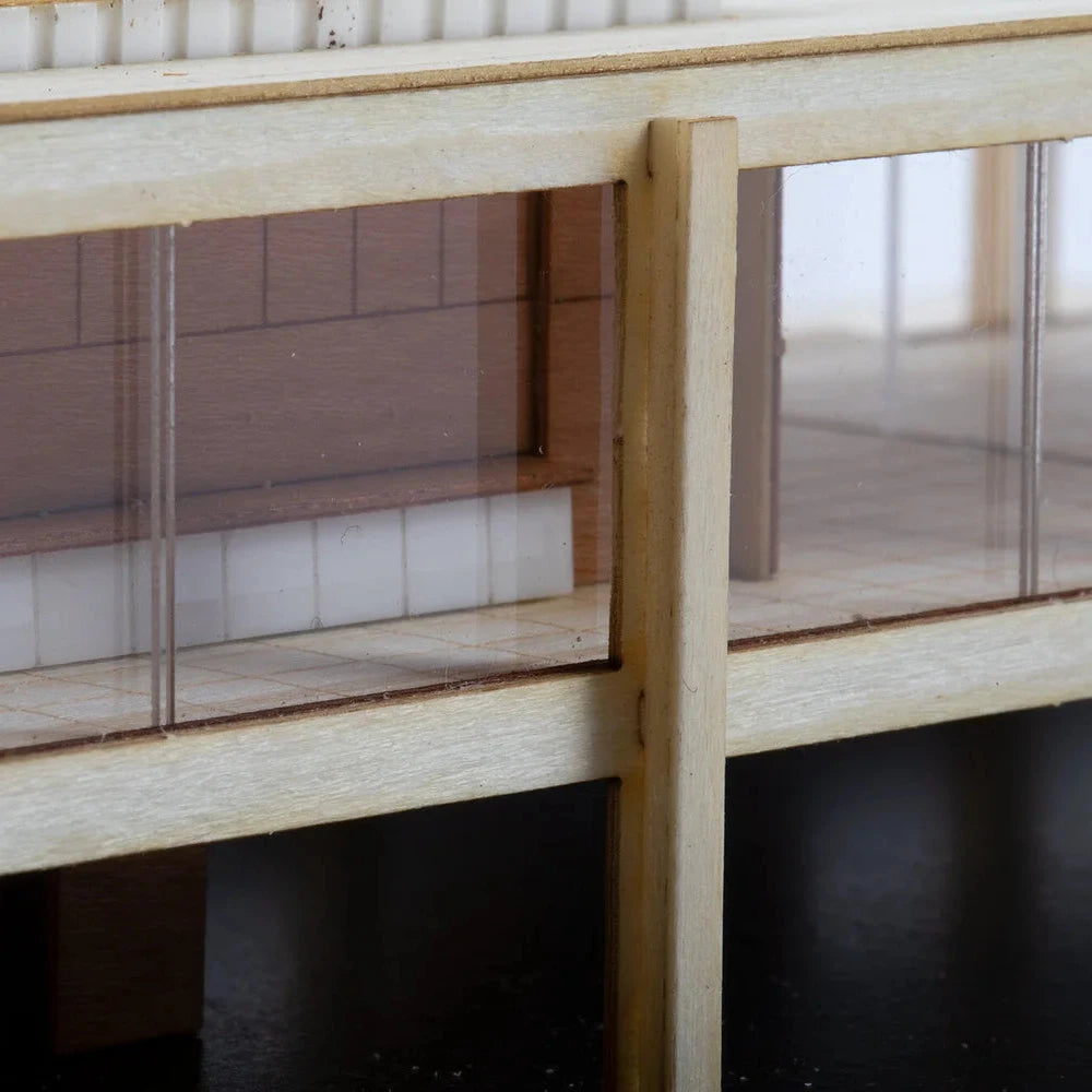 Model of a building with glass panels and wooden structure