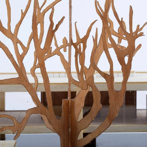 Wooden tree-like structure with a white table in the background