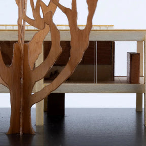 Wooden tree-like structure with a shelf on a white background