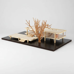 Wooden model of a tree and architectural structures on a black base