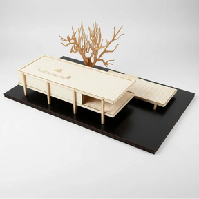 Model of a modern architectural design with a tree on a black base