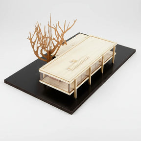 Model of a modern architectural structure with a tree on a black base