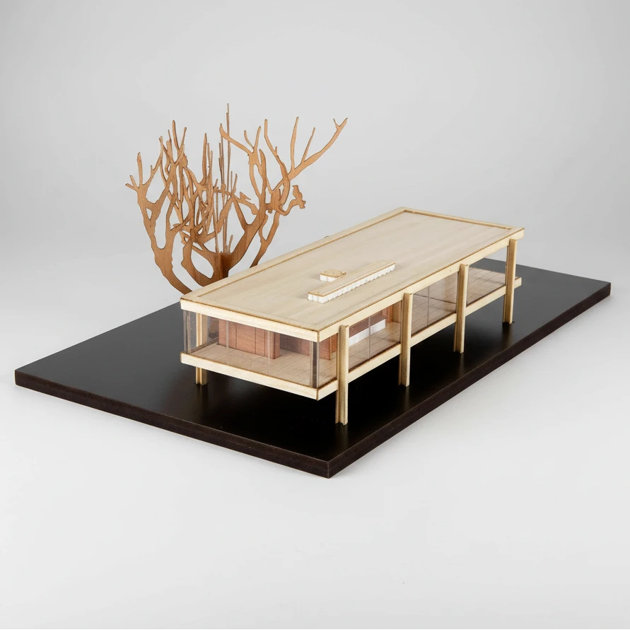 Model of a modern building with a tree-like sculpture on a black base