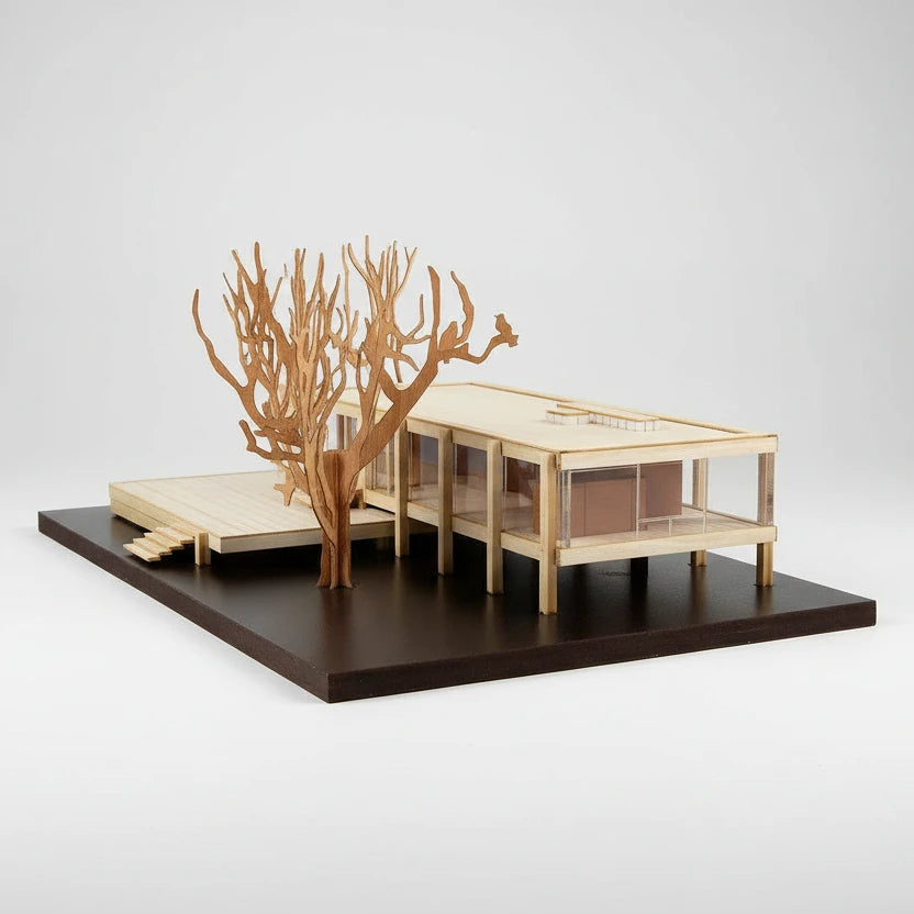 Model of a house with a tree on a white background