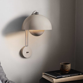 Wall-mounted lamp casting a warm glow on a neutral background