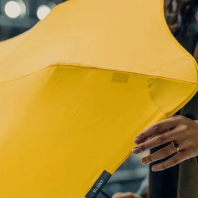 Close-up of a yellow umbrella with a blurred background