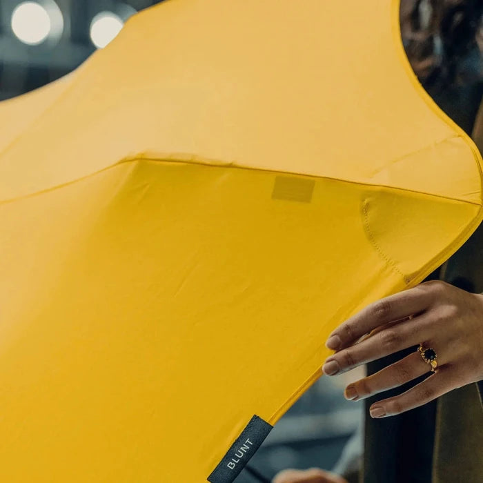 Close-up of a yellow umbrella with a blurred background