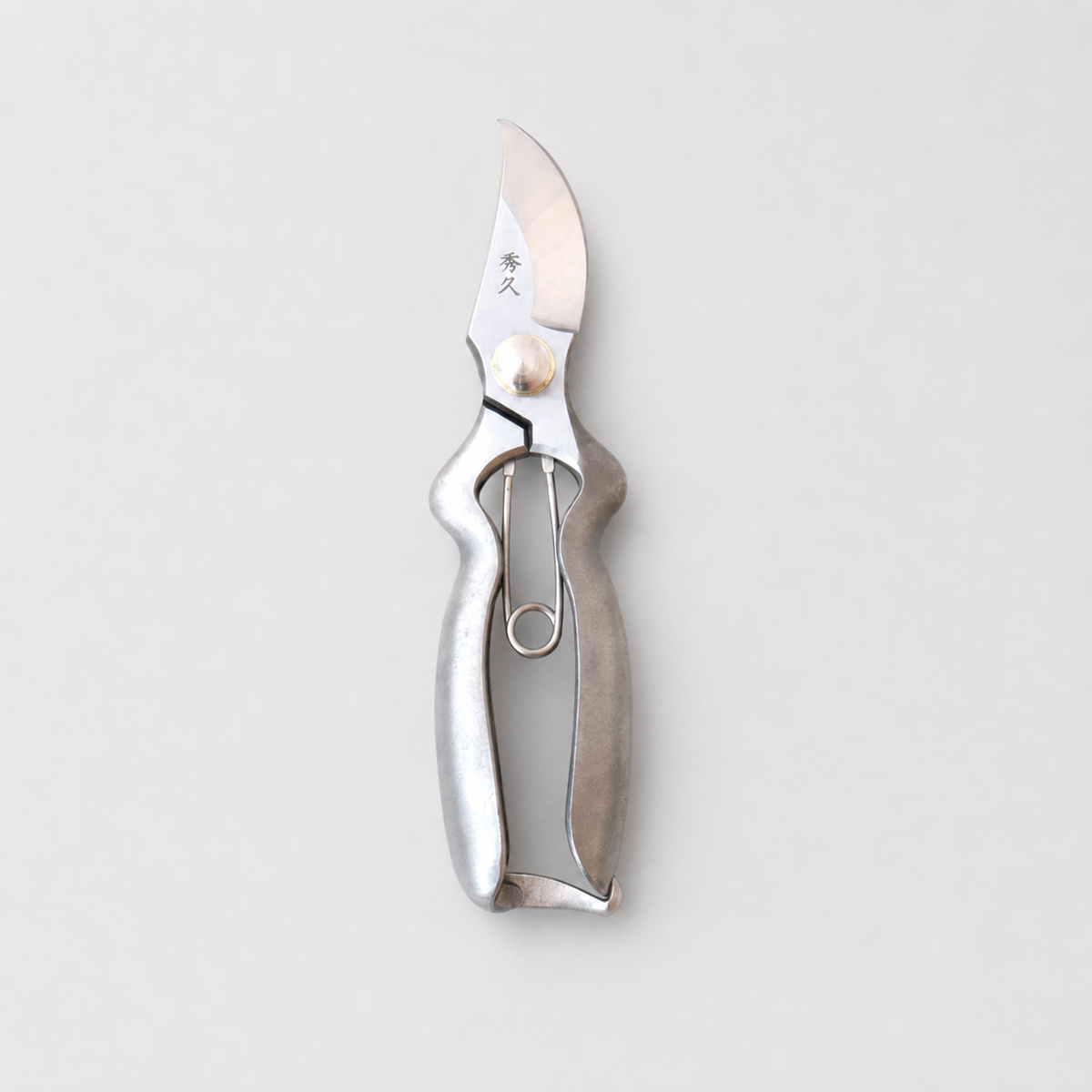 A silver metal pruning knife with a polished blade and textured handle, shown vertically against a light gray background.