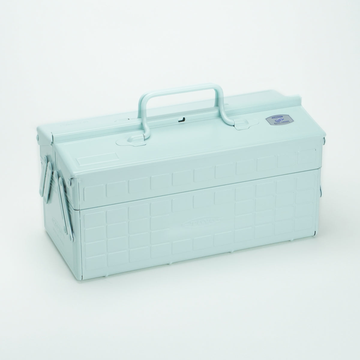 Glacier Toyo steel cantilever toolbox, closed, shown at a three-quarter angle with embossed grid panels, folded side arms, and a fixed top carry handle on a white background.