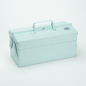 Glacier Toyo steel cantilever toolbox, closed, shown at a three-quarter angle with embossed grid panels, folded side arms, and a fixed top carry handle on a white background.
