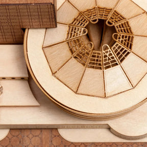 Wooden architectural model with intricate details on a wooden surface