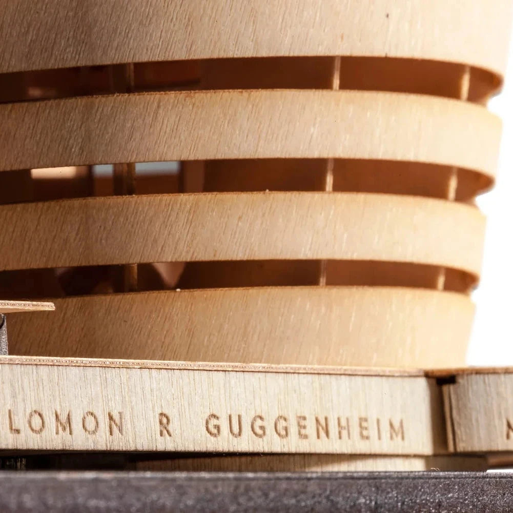 Close-up of a wooden architectural model with 'Solomon R Guggenheim Museum' branding.
