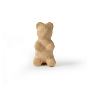 Wooden bear-shaped object on a white background