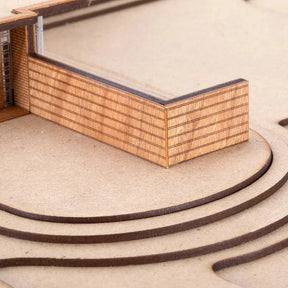 Model of a building with a wooden facade and steps leading up to it