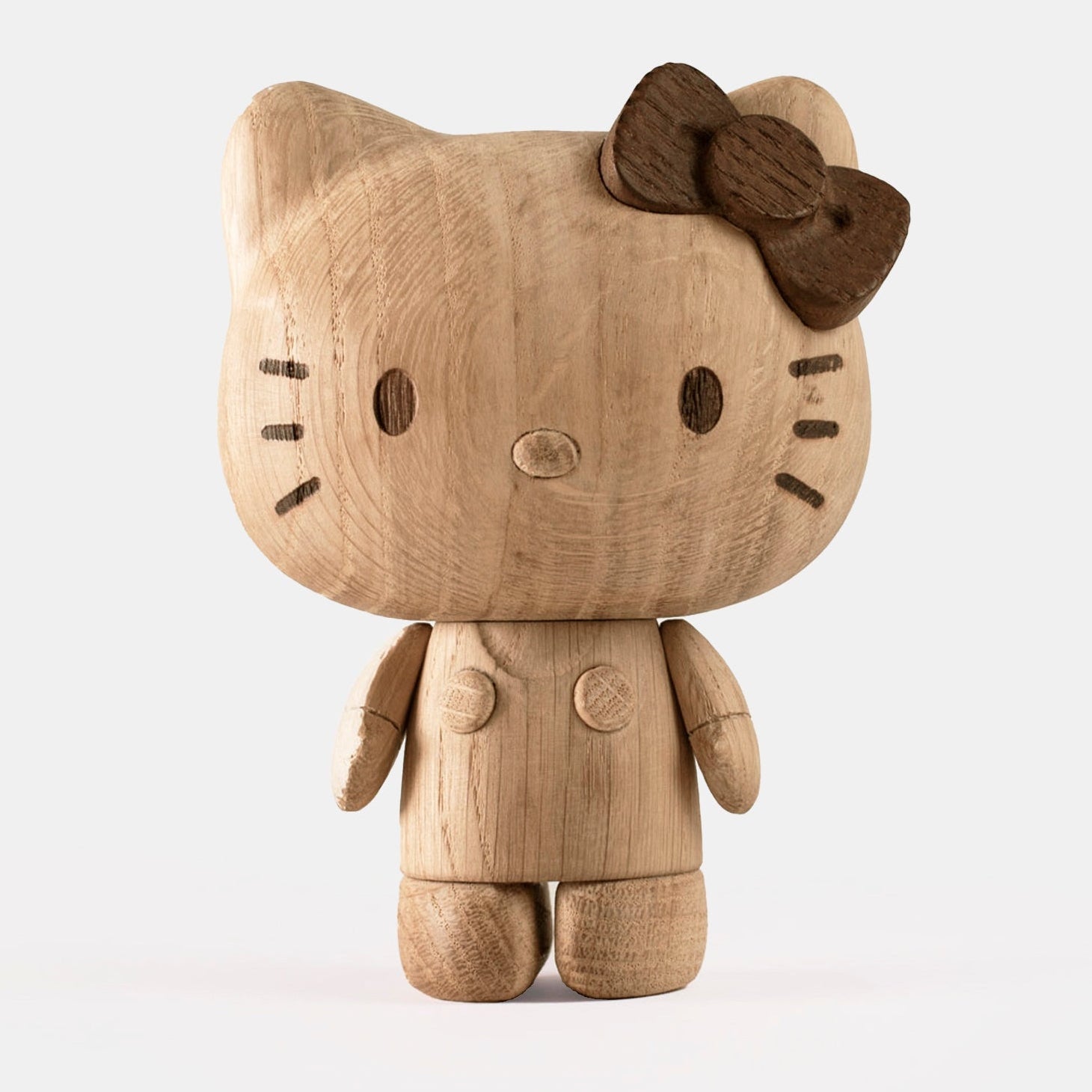 Wooden Hello Kitty toy with a bow on a white background