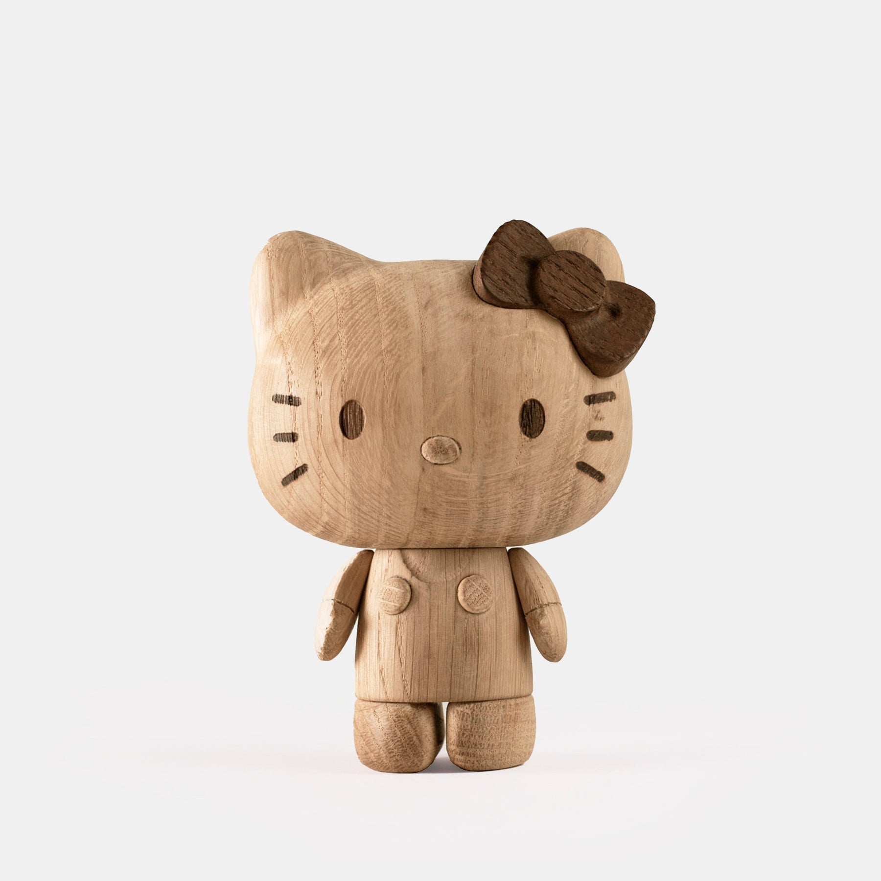 Wooden Hello Kitty toy with a brown bow on a white background