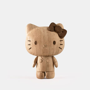 Wooden Hello Kitty toy with a brown bow on a white background