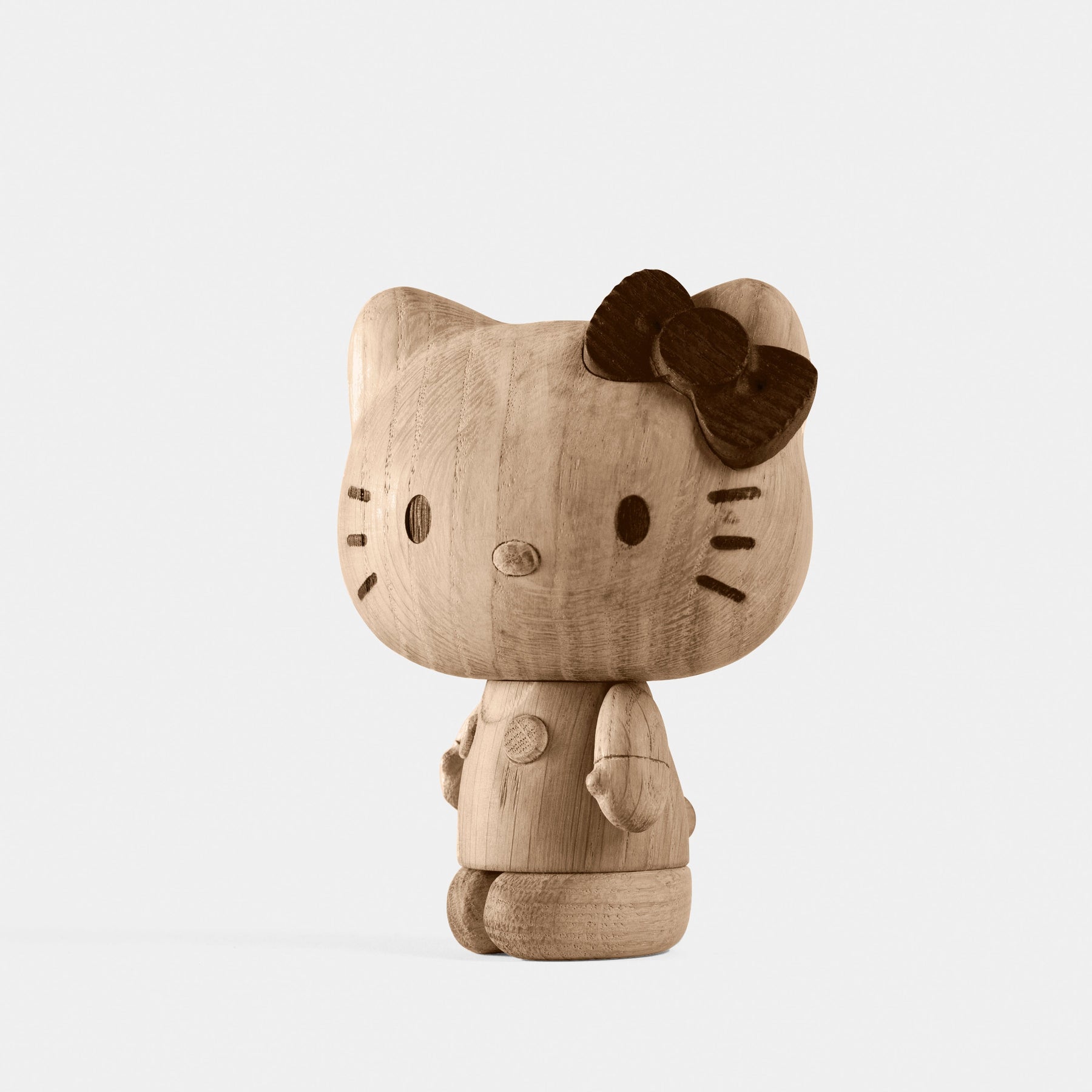 Wooden Hello Kitty figurine on a white background