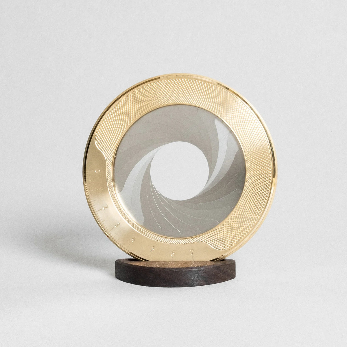 Decorative object with gold circular design on a white background