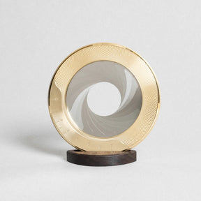 Decorative object with gold circular design on a white background