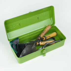 Open green Toyo Steel Y-350 metal toolbox containing gardening hand tools with wooden handles, including a trowel and pruners, shown on a white background.
