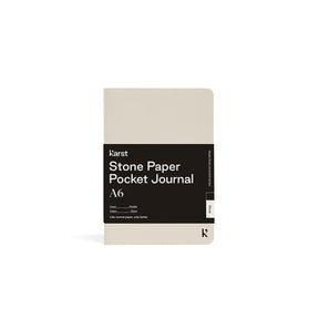 Beige pocket journal with black label on a white background