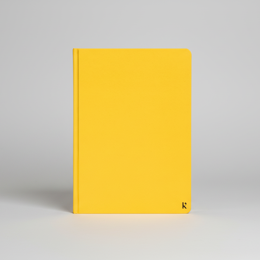 Karst A5 hardcover Stone Paper Notebook in Lemon yellow with minimalist design and embossed logo, shown against a light gray background.