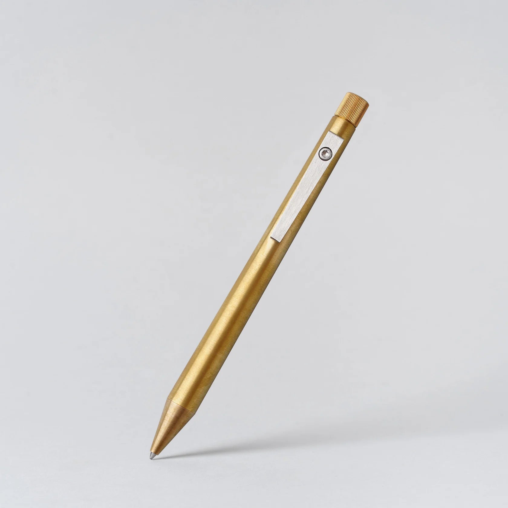 Gold pen on a light gray background