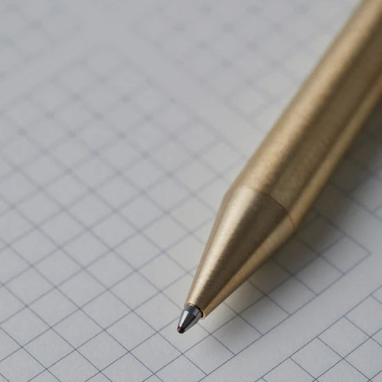 Gold pen on a grid background